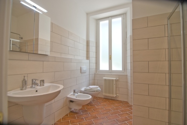 main bathroom with shower & washing machine